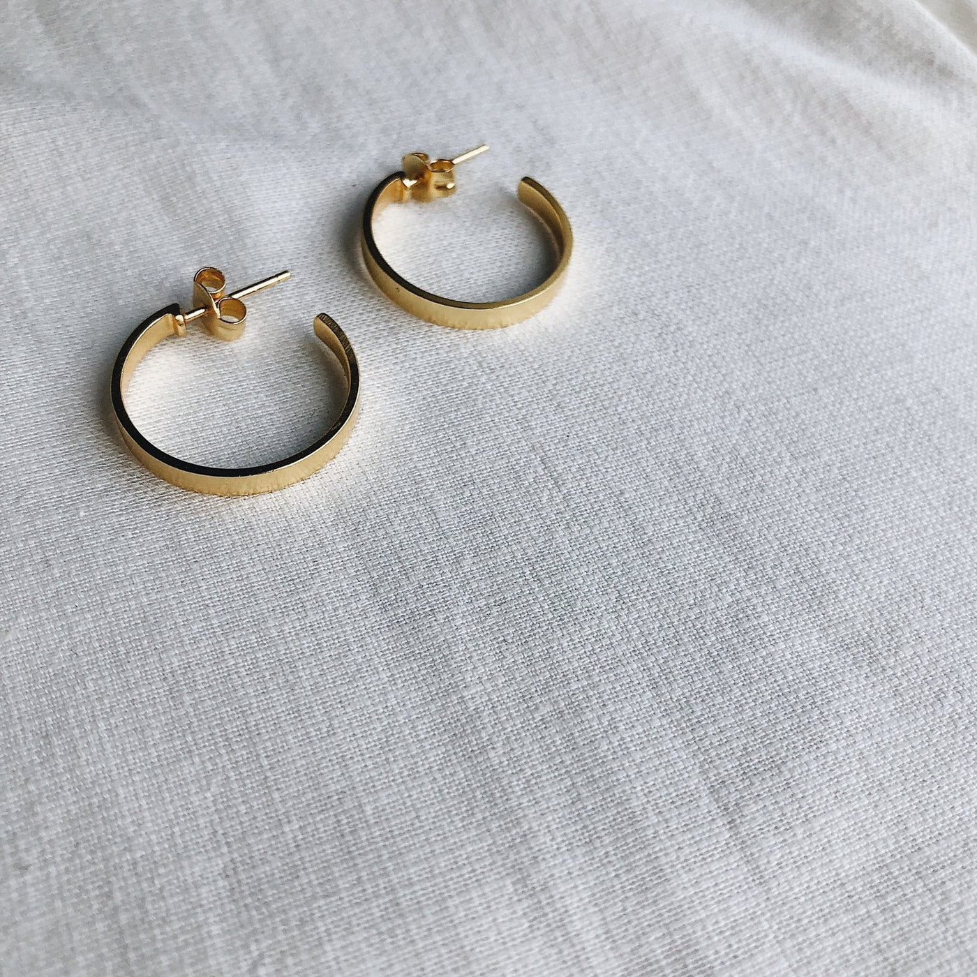 gold open hoop earring lines and current